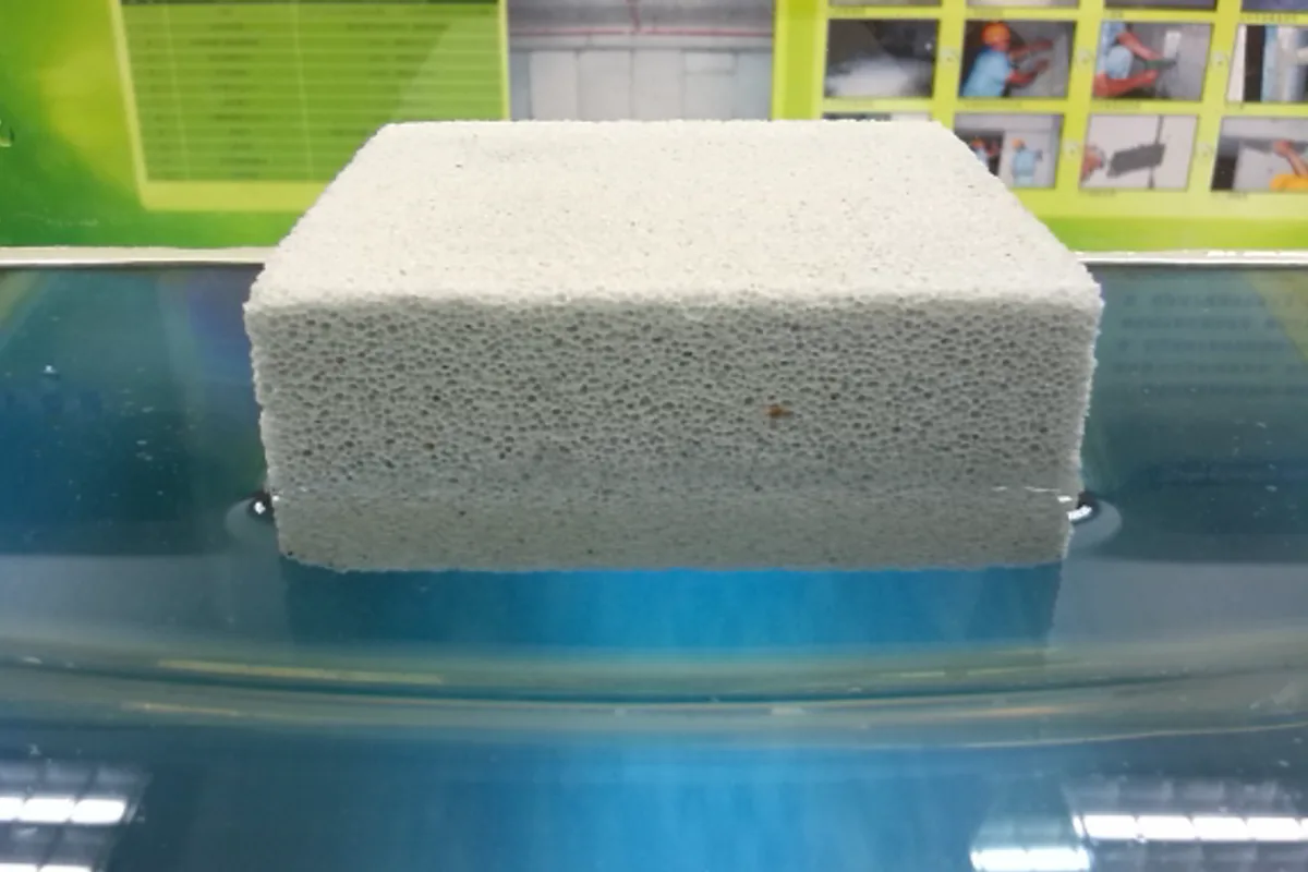 A block of foamed ceramic floating on water