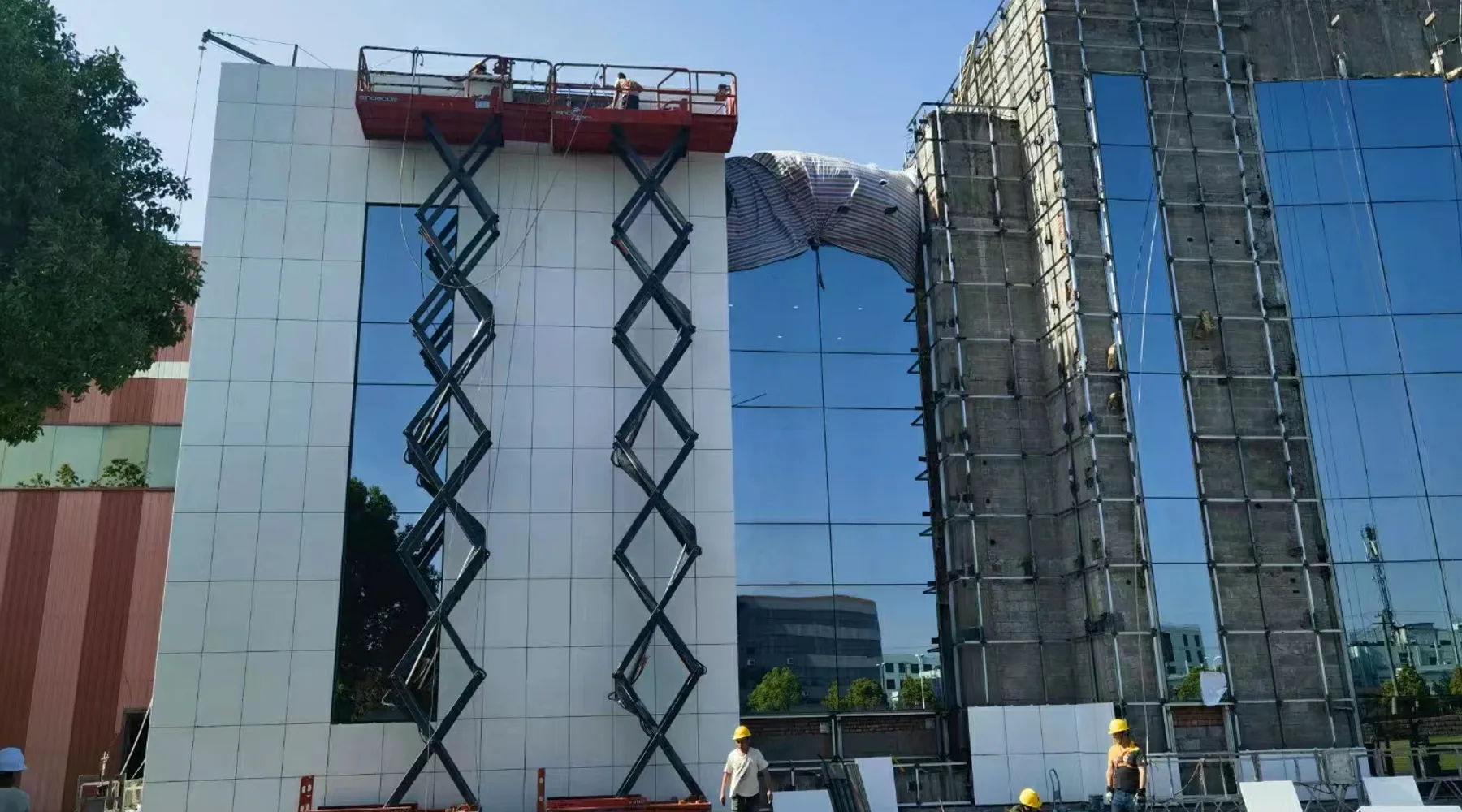 Foamed ceramic composite panels being installed on a building facade